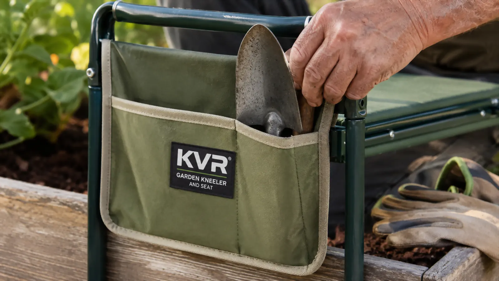 Close-up of a faded green tool pouch attached to the kneeler's steel arm rail, holding a hand trowel